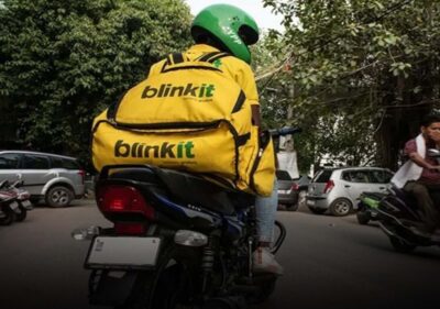 Blinkit delivery partner riding bike after 10-minute delivery promise withdrawn